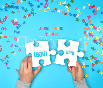 women hand hold  large white puzzles and the inscription join ou