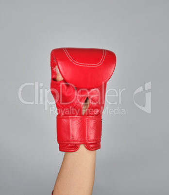 raised up hand in red boxing glove