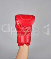 raised up hand in red boxing glove