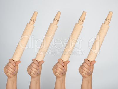 hands hold kitchen wooden rolling pins