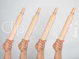 hands hold kitchen wooden rolling pins