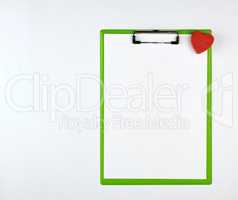 paper clipboard and red heart on a white background