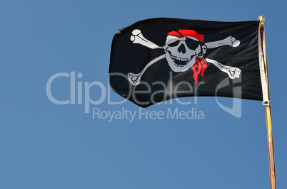 Pirate flag against blue sky, copy space