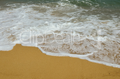Paradise beach, golden sand, waves and sea foam