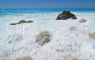 Big stone covered by sea foam, Lefkada, Greece