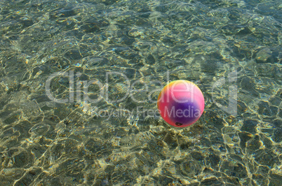 Beach ball on the surface of the water