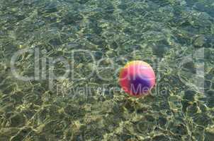 Beach ball on the surface of the water