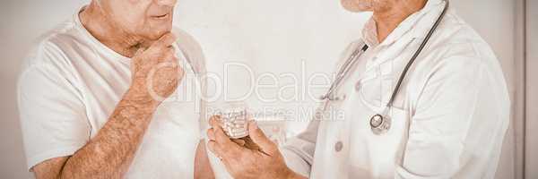 Male doctor advising senior man on medical prescriptions