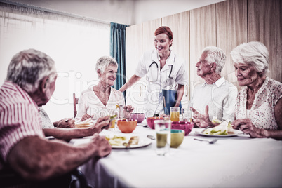 Pensioners at lunch with nurse