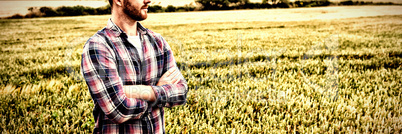 Farmer standing with arms crossed while looking away