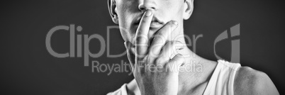 Androgynous man posing with finger on lips Androgynous man posing with finger on lips
