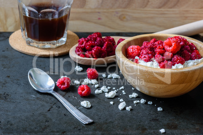 Sweet breakfast with cottage cheese, raspberries and cup of coffee.