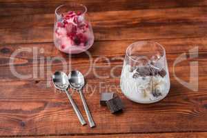 Two portions of vanilla and strawberry ice cream in glass