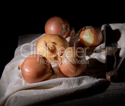 unpeeled round brown onions