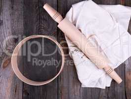 new wooden rolling pin on a textile napkin with embroidery and a