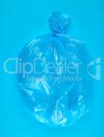 blue plastic bag for garbage on a blue background