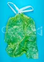 empty green plastic garbage bag with handles