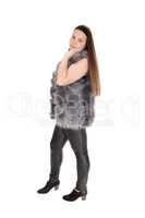 A pretty teenager girl standing in leather pants
