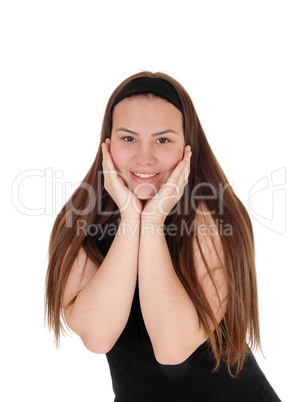 Pretty teen girl standing with booths hands on face