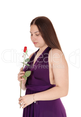 Lovely teenager girl holding a red rose