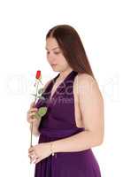 Lovely teenager girl holding a red rose