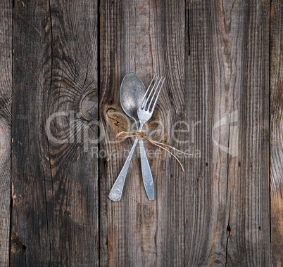 old metal fork and spoon tied with a brown rope