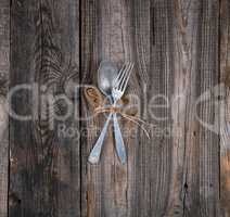 old metal fork and spoon tied with a brown rope
