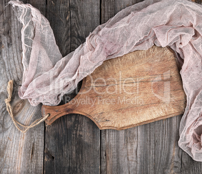 very old brown  cutting board with a handle