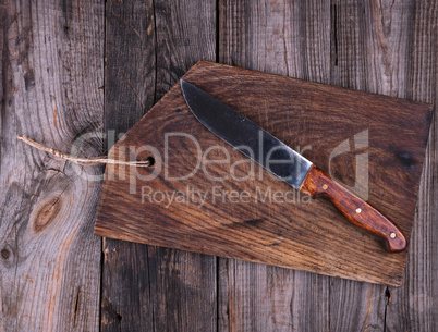 empty old brown wooden cutting board and knife