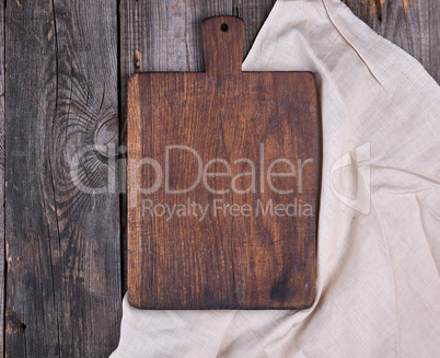 empty old brown wooden cutting board with handle