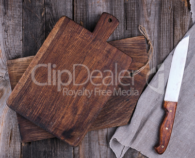two old wooden cutting boards and a knife