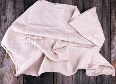 textile dishcloth with embroidery on a gray wooden background