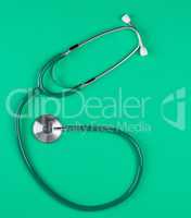 medical stethoscope on green background