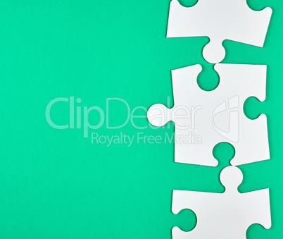 blank white big puzzles on green background