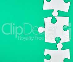 blank white big puzzles on green background