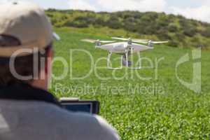 UAV Drone Pilot Flying and Gathering Data Over Country Farm Land