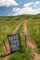 Dead End Keep Out Sign On Wire Fence At Dirt Road