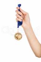 Girl hand raised holding gold medal