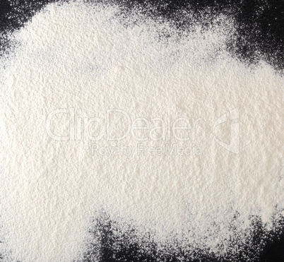 sprinkled white flour on the black table