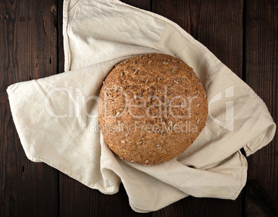 baked round rye bread with sunflower seeds