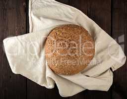 baked round rye bread with sunflower seeds