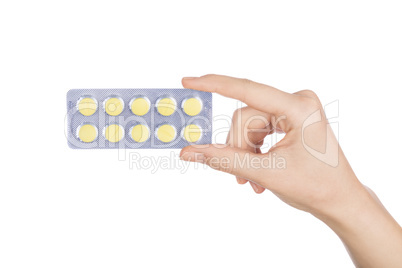 Woman hand holding pills tablet