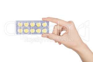 Woman hand holding pills tablet