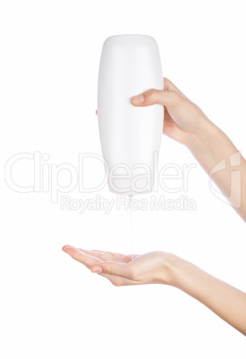 White bottle of shower gel lotion cream in hands