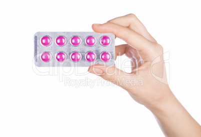 Woman hand holding pills tablet