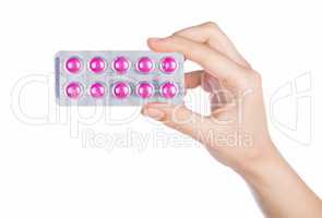 Woman hand holding pills tablet
