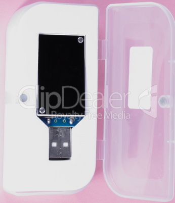 electronic device in plastic case on pink background at day