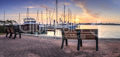 Break of dawn sunrise over boats and sailboats at Factory Bay ma