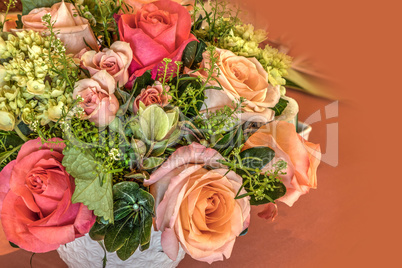 Pale peach roses, green hydrangea, and pink roses in a bouquet