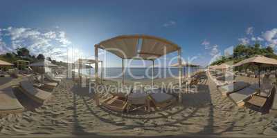360 VR Sea and empty deck-chairs on shore. Vacation in Trikorfo Beach, Greece